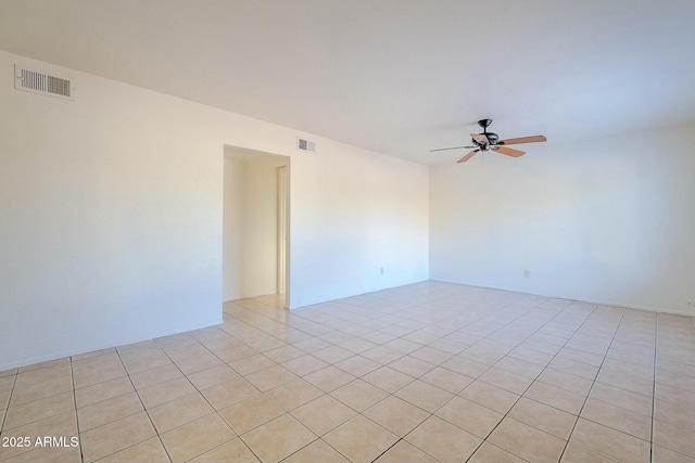 spare room featuring ceiling fan and light tile patterned floors