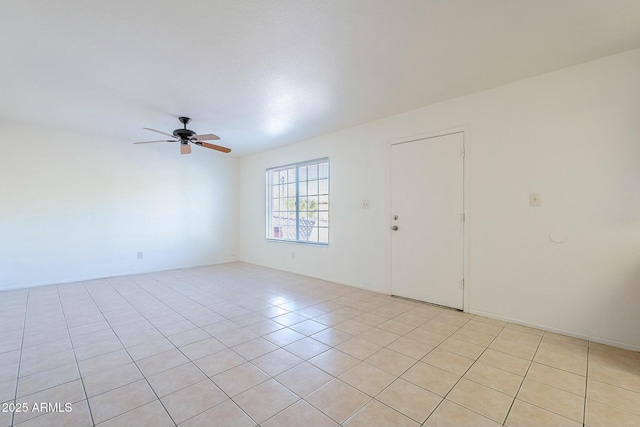 empty room with light tile patterned floors and ceiling fan