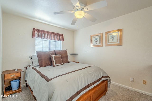 bedroom featuring light carpet, ceiling fan, and baseboards