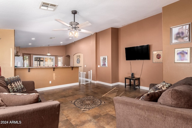 living room featuring vaulted ceiling and ceiling fan