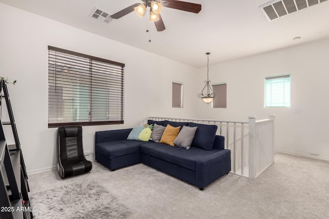 living room with light carpet and ceiling fan