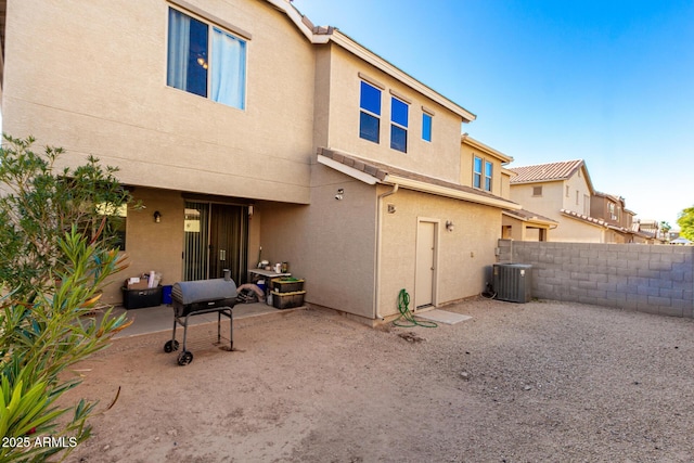 rear view of house featuring a patio and central AC