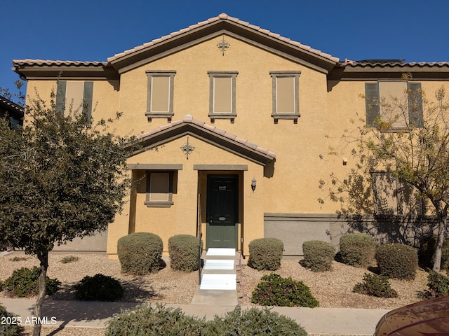 view of front facade featuring a tile roof and stucco siding