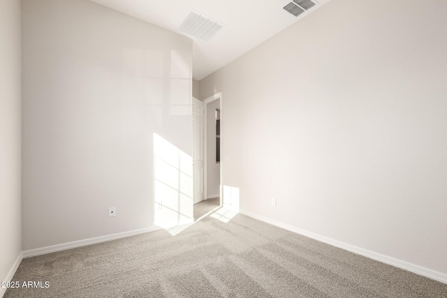 unfurnished room featuring light carpet