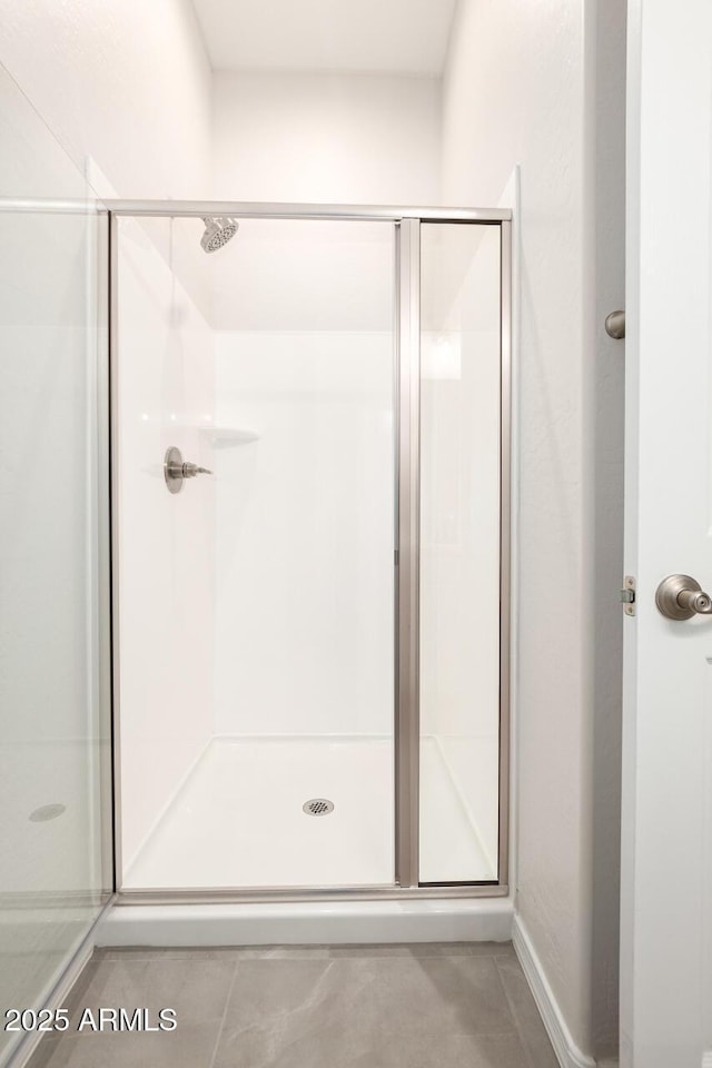 bathroom featuring a shower with shower door