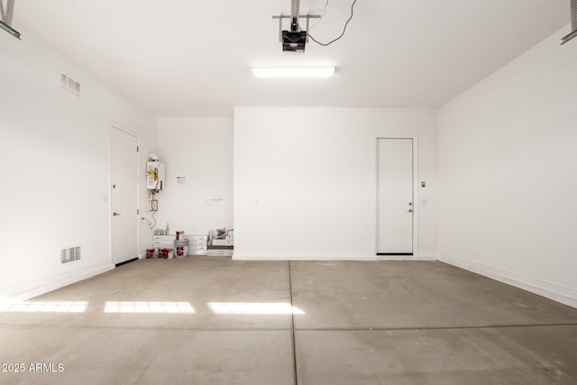 garage with a garage door opener and water heater