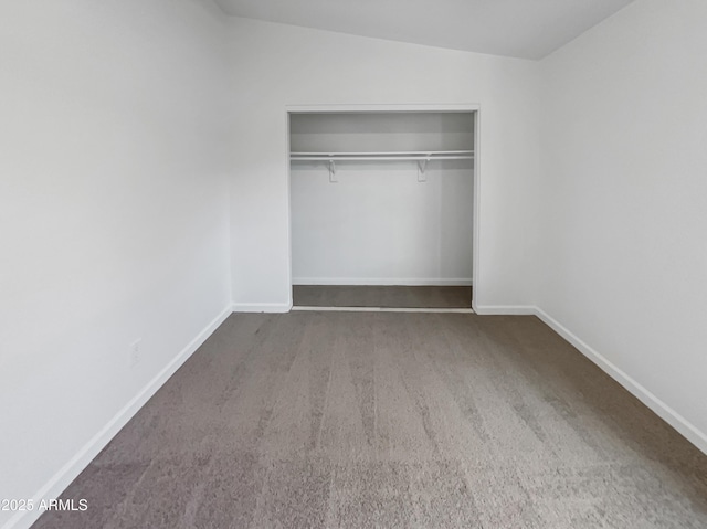 unfurnished bedroom featuring a closet and carpet