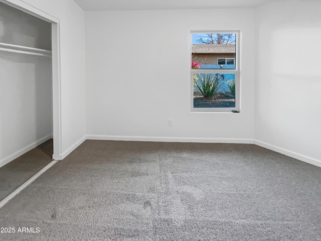 unfurnished bedroom featuring carpet flooring and a closet