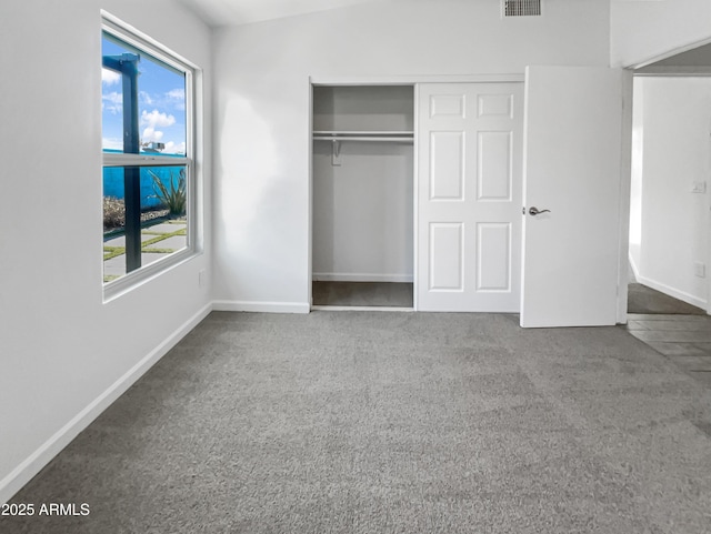 unfurnished bedroom with a closet and carpet floors