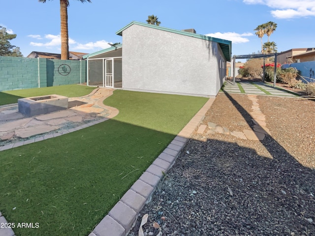 view of yard with an outdoor fire pit