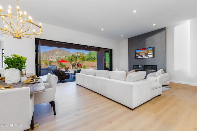 living room with a tile fireplace and light hardwood / wood-style flooring