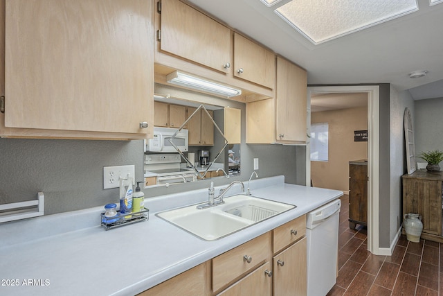 kitchen featuring light brown cabinets, sink, and white appliances