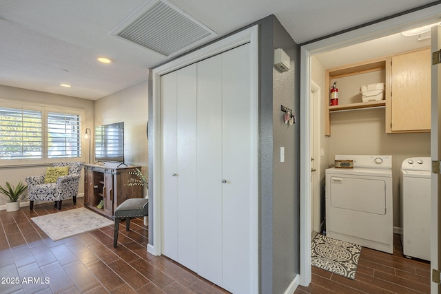 washroom with cabinets and separate washer and dryer