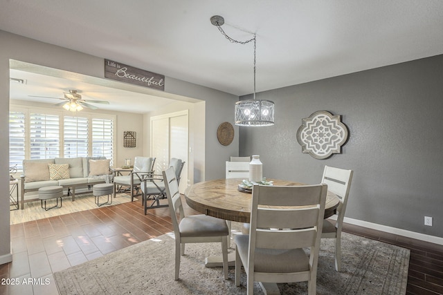 dining room with ceiling fan with notable chandelier