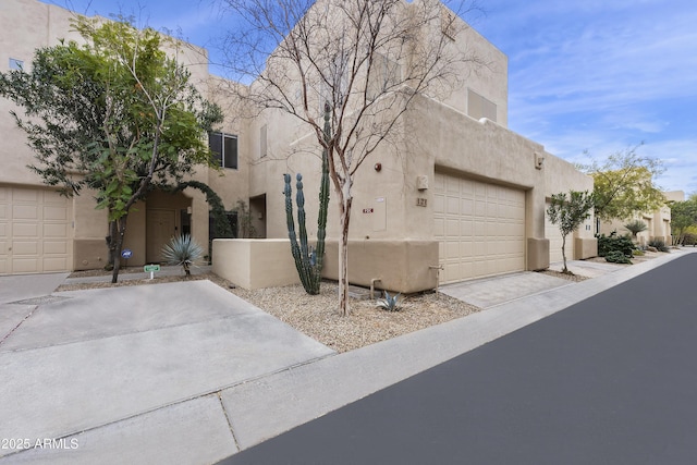 pueblo-style house with a garage