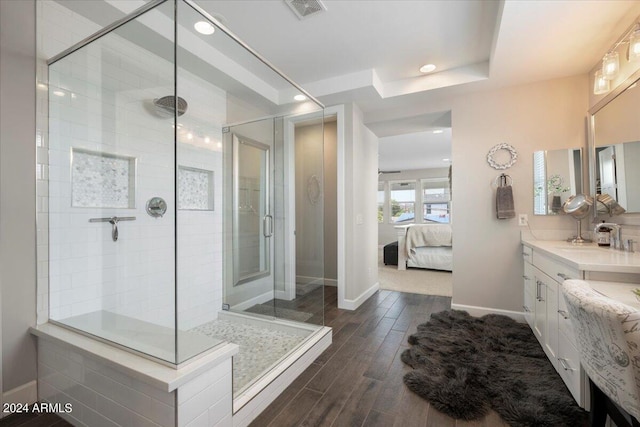 bathroom featuring vanity, hardwood / wood-style flooring, and a tile shower