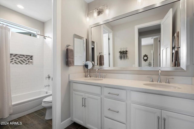 full bathroom featuring vanity, shower / bathtub combination with curtain, and toilet