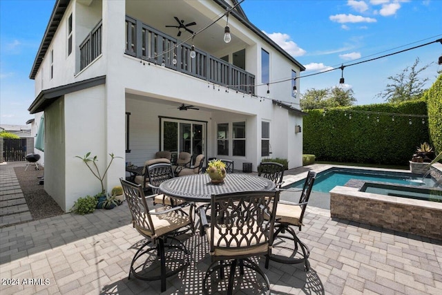 rear view of house featuring a patio area, pool water feature, ceiling fan, and a balcony