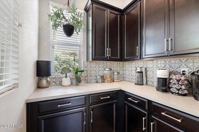 kitchen featuring decorative backsplash and dark brown cabinets