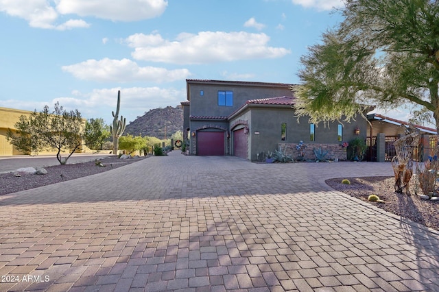 mediterranean / spanish home with a mountain view and a garage