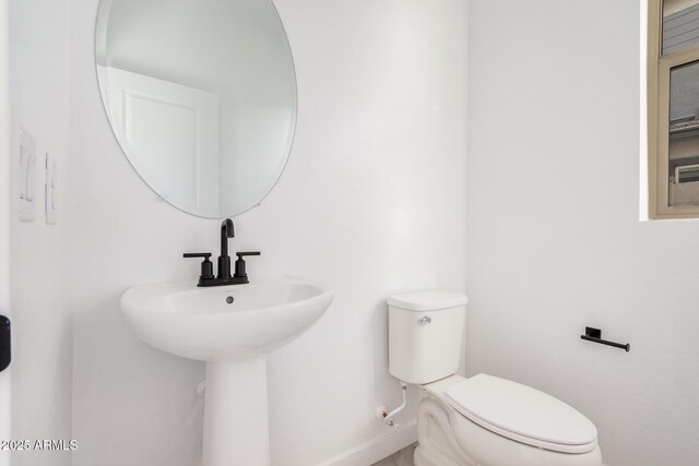 bathroom featuring toilet and sink