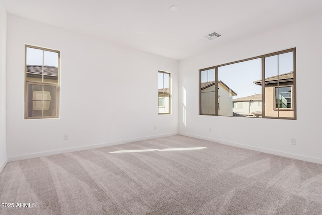 unfurnished room with plenty of natural light and carpet