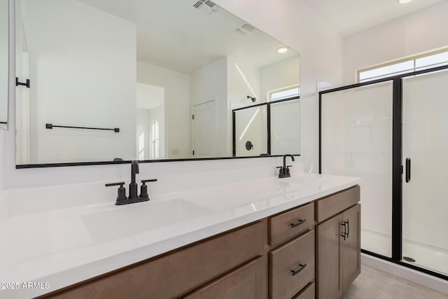 bathroom featuring vanity and a shower with door