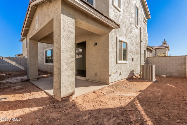 back of house featuring central AC and a patio area