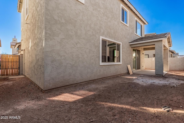 back of property with a patio