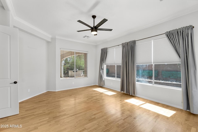 unfurnished room featuring a ceiling fan, visible vents, crown molding, baseboards, and light wood finished floors