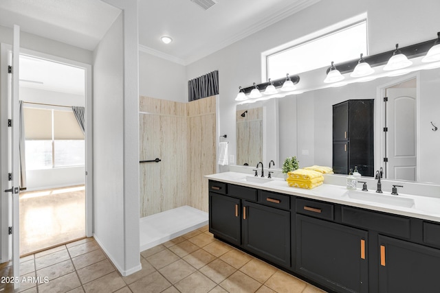 full bath featuring a sink, tile patterned flooring, and crown molding