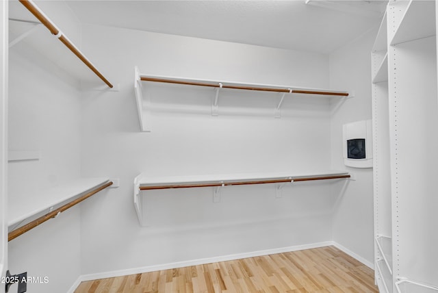 spacious closet with light wood-style flooring