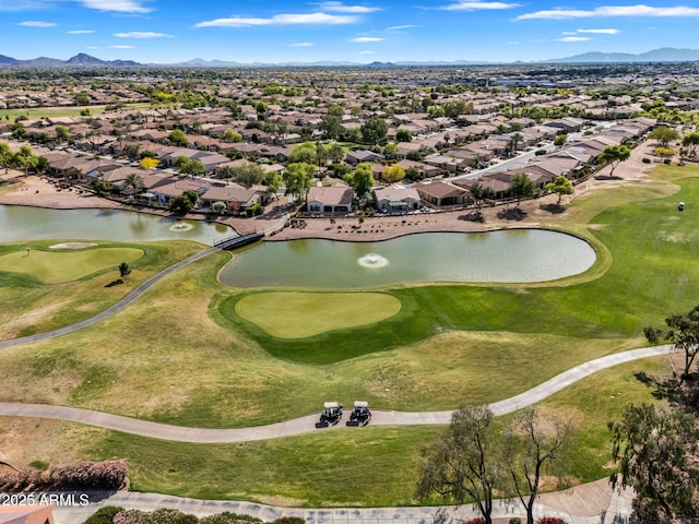 birds eye view of property with a water and mountain view, golf course view, and a residential view