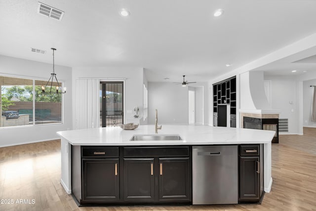 kitchen featuring a sink, light countertops, visible vents, and dishwasher