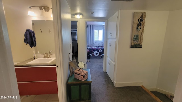 bathroom with vanity and baseboards