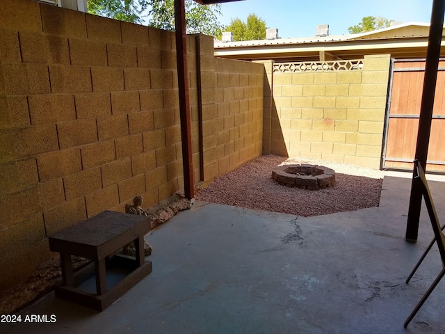 view of patio with an outdoor fire pit and a fenced backyard