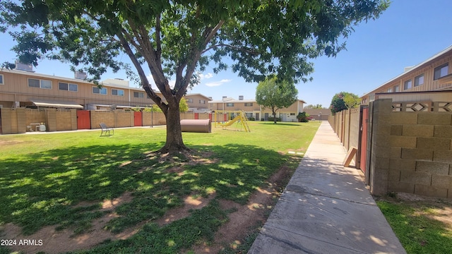 view of yard with a residential view, a playground, and fence