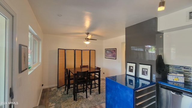 kitchen with dishwasher, dark countertops, ceiling fan, wood finished floors, and fridge