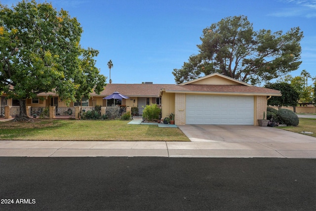 ranch-style home with a front lawn and a garage