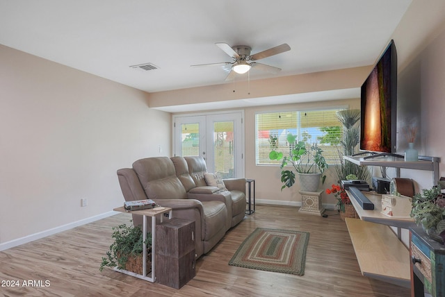 living room featuring ceiling fan, light hardwood / wood-style floors, and french doors