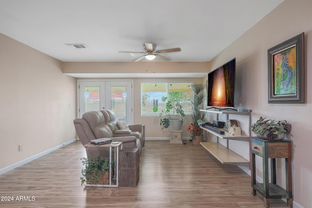 living room featuring ceiling fan, light wood-type flooring, and french doors