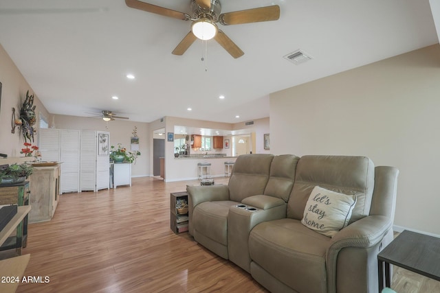 living room with light hardwood / wood-style floors and ceiling fan