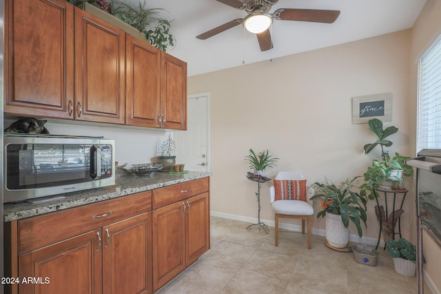 kitchen featuring stone counters and light tile patterned floors