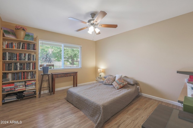 bedroom with light hardwood / wood-style flooring and ceiling fan