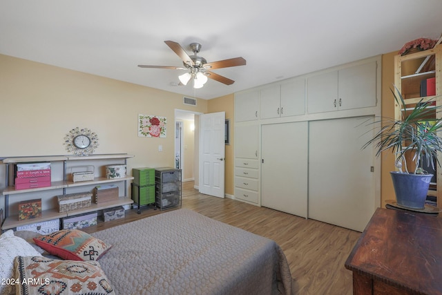 bedroom featuring hardwood / wood-style floors, a closet, and ceiling fan