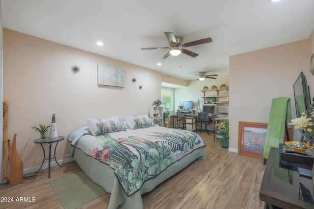 bedroom with ceiling fan and light hardwood / wood-style floors