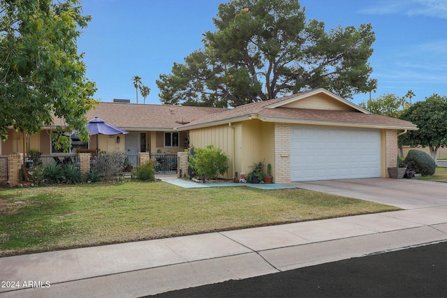 ranch-style home with a front yard and a garage