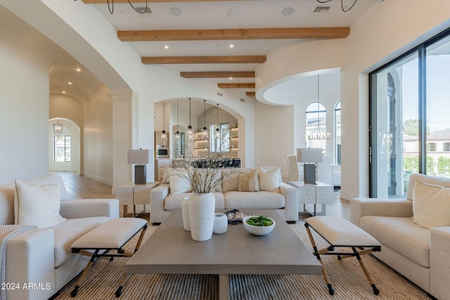 living room with beamed ceiling and a chandelier