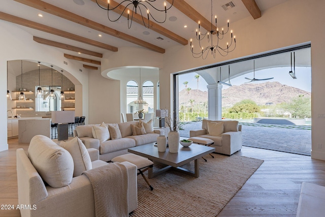 living room featuring a mountain view, beam ceiling, and light hardwood / wood-style floors