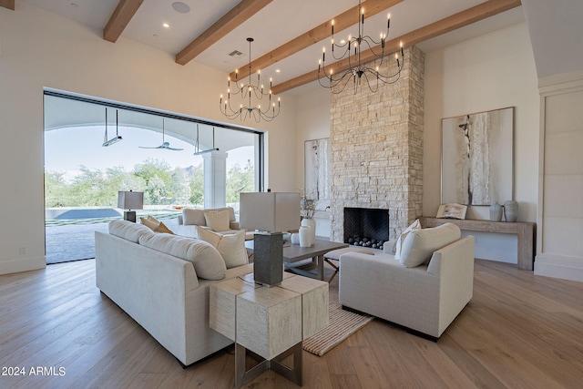 living room with beam ceiling, a stone fireplace, a high ceiling, and hardwood / wood-style floors